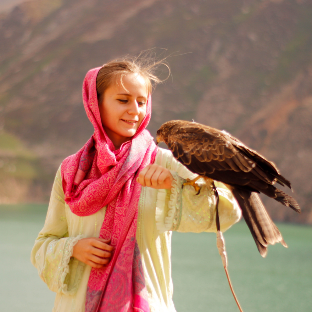 Posing for photos with a falcon at Lulusar Lake near Naran, Pakistan