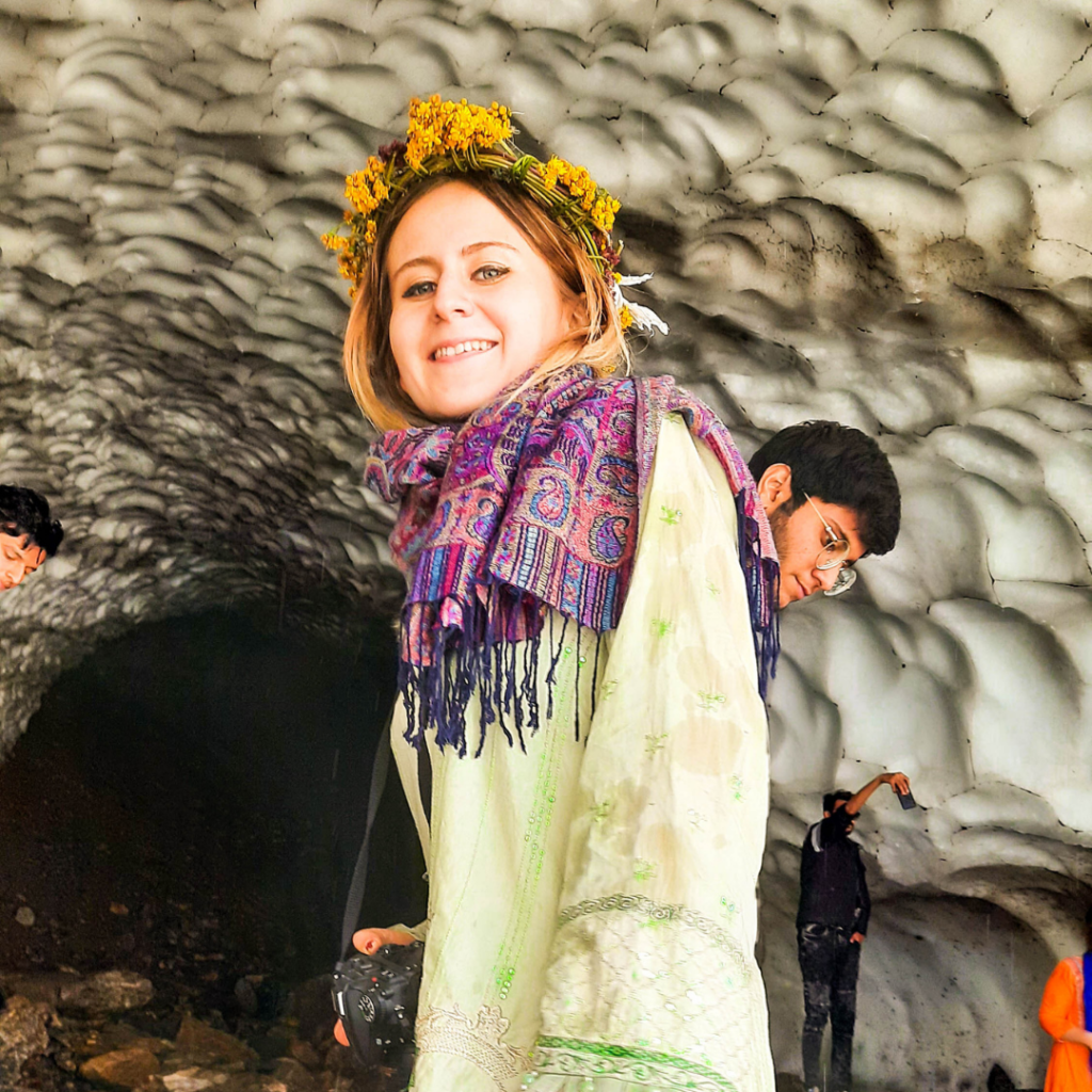 Awkwardly posing inside a glacier cave near Naran, Pakistan, with icy water dripping on my head.