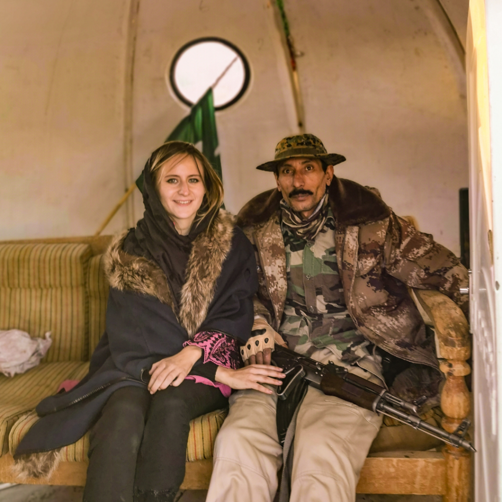 Warm Encounters At The Icy Border: Visiting Khunjerab Pass From Hunza Valley 16 Foreign girl and Pakistani border officer posing inside a checkpoint booth at the Pakistan-China border at Khunjerab Pass.