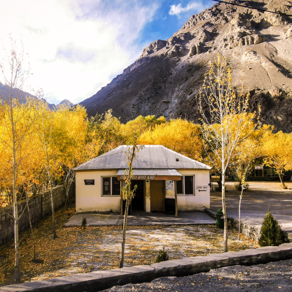Warm Encounters At The Icy Border: Visiting Khunjerab Pass From Hunza Valley 8 Khunjerab National Park check post office covered in yellow leaves in October.