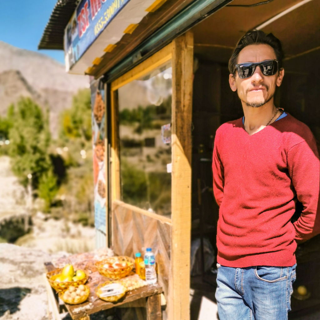 Hunza Valley, Pakistan: A Full Guide To Pakistan's Jewel Of The North 15 A shop keeper in Hunza Valley selling local produce to tourists.