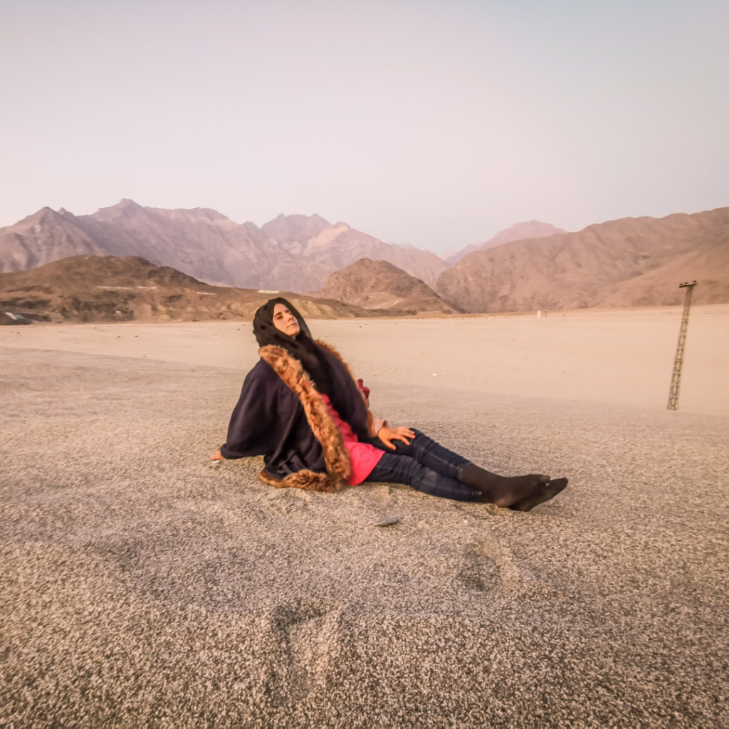 A Complete Travel Guide To Skardu, Pakistan 13 Girl lying down in the sand at Sarfarangah Cold Desert near Skardu, Pakistan.