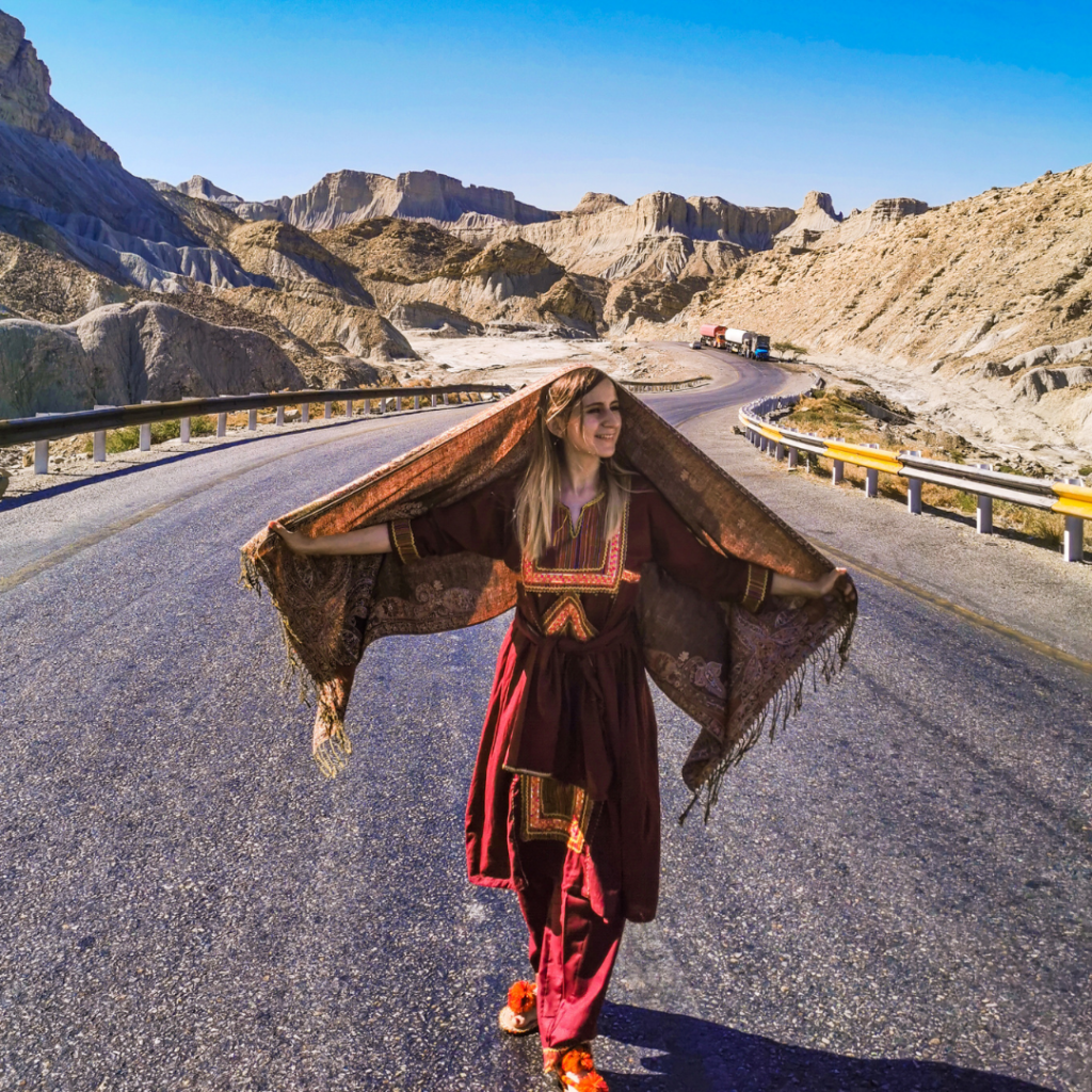Full Itinerary For An Incredible Balochistan Day Trip From Karachi 9 Foreign girl in traditional Balochi dress standing on Makran Coastal Highway in Hingol National Park, Balochistan, Pakistan.