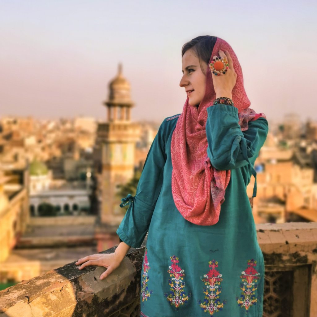 Foreign girl in Pakistani dress on the minaret of the Wazir Khan Mosque in Lahore, Pakistan.