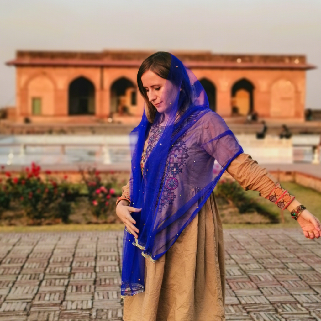 Foreign girl in traditional clothes at Lahore Fort, Pakistan.