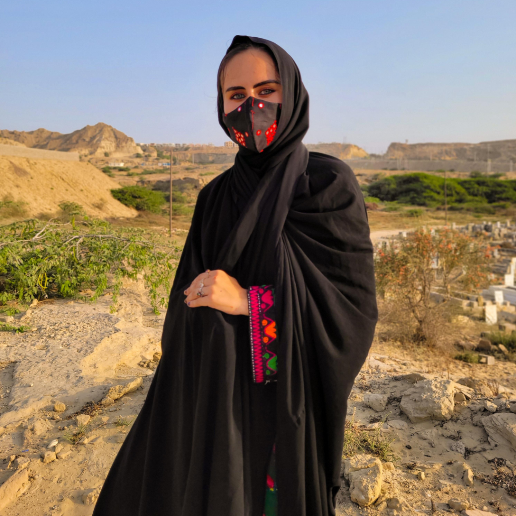 Girl in black chador next to the Jinn Cemetery in Tis, Iran.