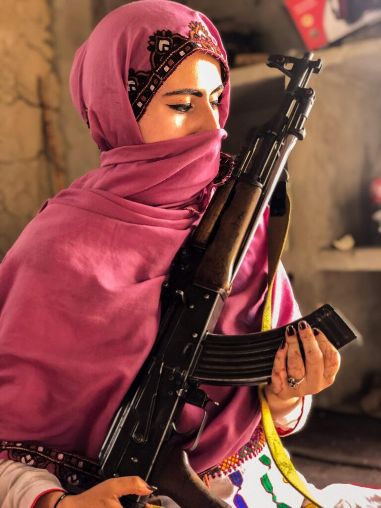 My Astonishing Visit To The Tribal Areas of Punjab, Pakistan 11 Girl in Balochi dress and purple niqab holding a big gun