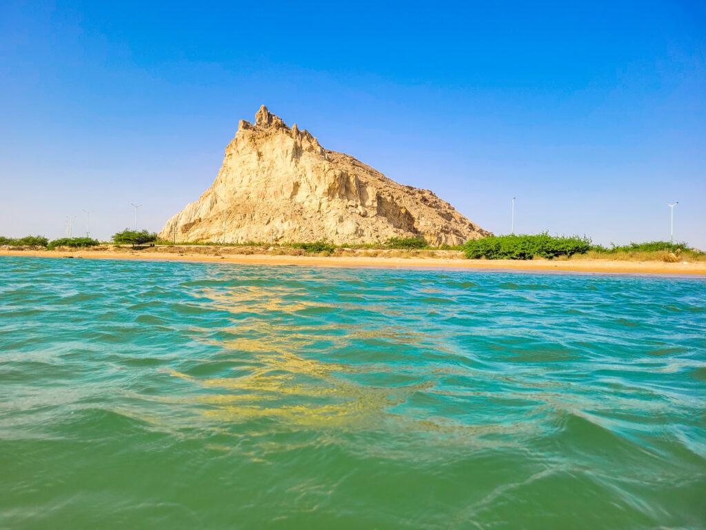 20 Stunning Places To Visit In Chabahar, Iran 15 View of a golden rock from the turquoise sea at Darya Kuchek Beach in Tis Village near Chabahar, Iran.