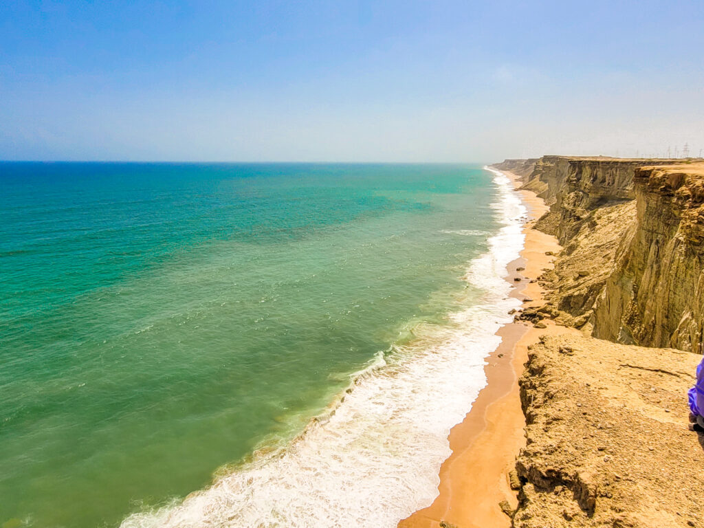 20 Stunning Places To Visit In Chabahar, Iran 20 A golden cliff on the right side and the turquoise-blue sea on the left. On the Makran Coast, near Chabahar, Balochistan, Iran.
