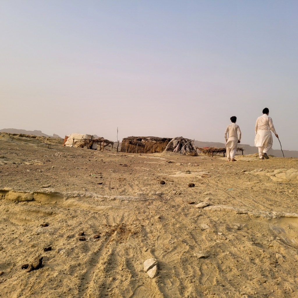 20 Stunning Places To Visit In Chabahar, Iran 26 Two shepherds walking next to a nomadic straw hut in the mountains near Chabahar, Balochistan